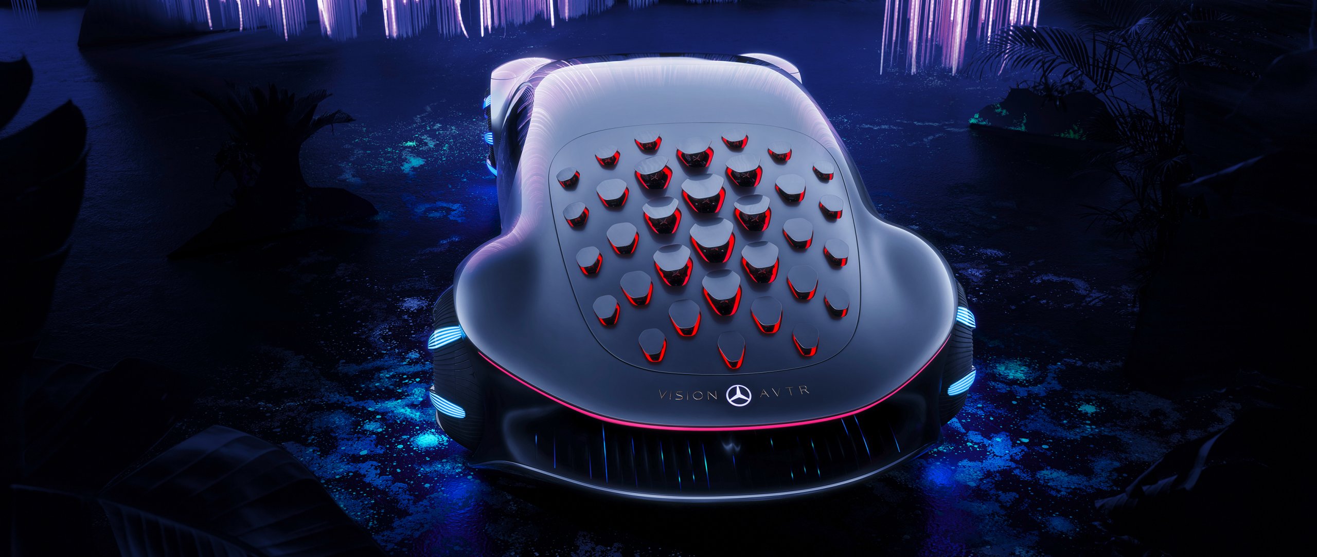 Rear view of the Mercedes-Benz VISION AVTR with red glowing solar plates on its back – inspired by AVATAR